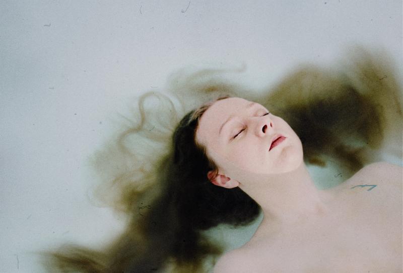 Salli floating in water for a time, with her long hair flowing in the water.